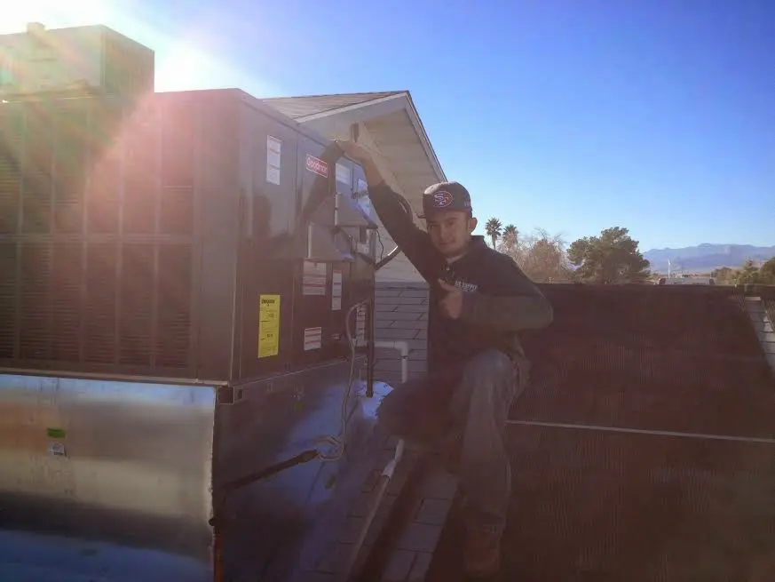 HVAC technician performing HVAC Inspection on a rooftop unit in New Britain